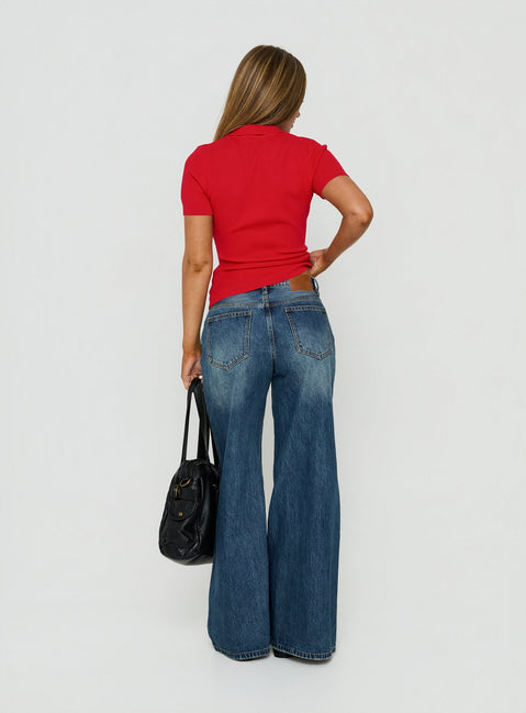 Presenting Celinia Mid Rise Asymmetrical Baggy Jeans Dark Indigo womens-jeans featuring mid-rise back view of model wearing Princess Polly
