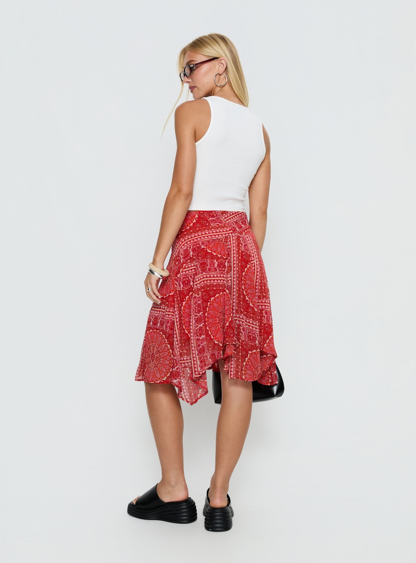 back view of model wearing Princess Polly Raenah Asymmetrical Midi Skirt Red Paisley 