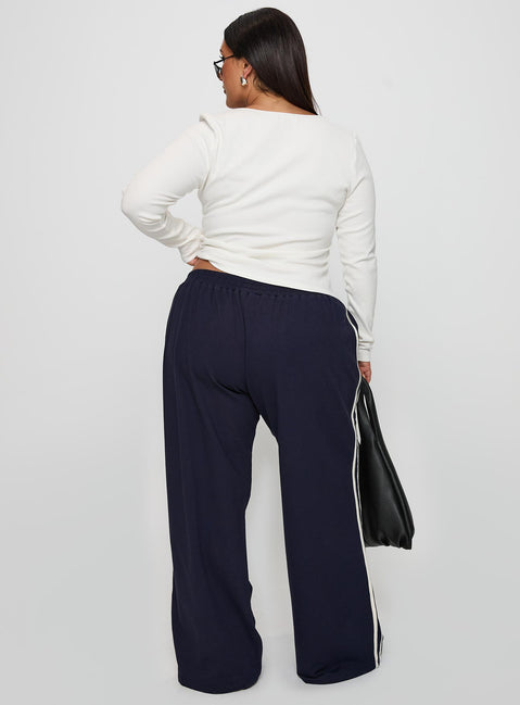 back view of model wearing Princess Polly Circuit Track Pants Navy Curve Pants 