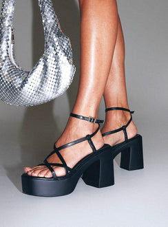 Heels Platform style, open toe, flared block heel Faux leather material, square open toe, thin upper straps Thin Ankle Strap with Adjustable Buckle Fastening