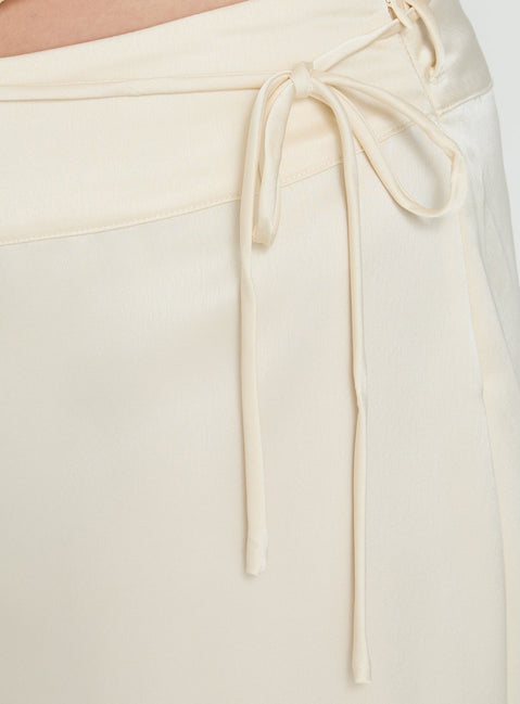 Highlighting the Aubrette Satin Tie Pants Cream Curve womens-regular-pants in high-rise with belt and wide-leg construction detail Princess Polly
