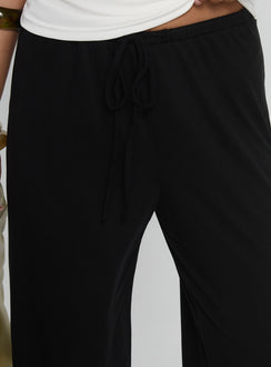 back view of model wearing Princess Polly Gavrielle Jersey Wide Leg Pants Black High Rise Pants 