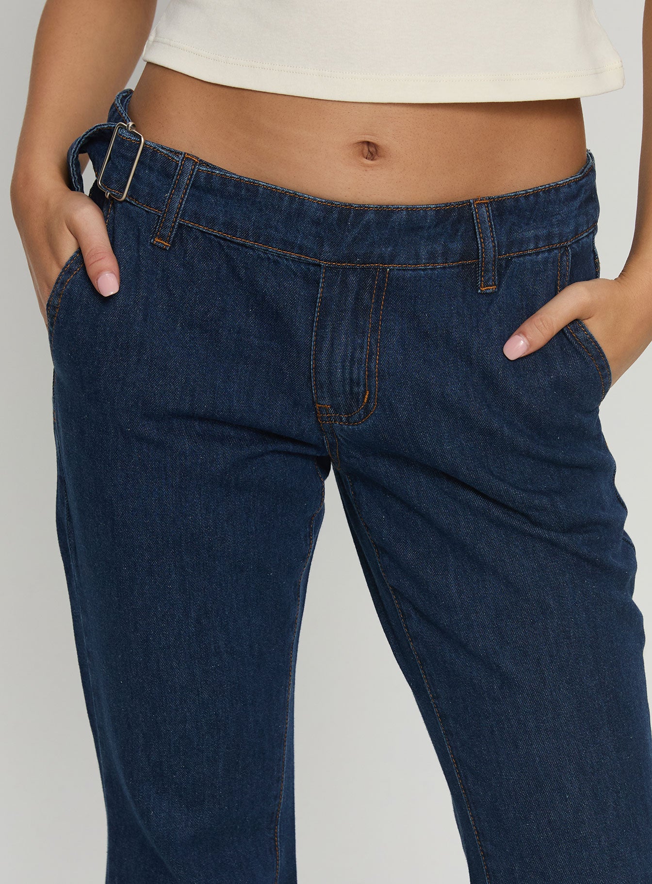 back view of model wearing Princess Polly Acapulco Low Rise Flare Jeans Dark Blue Wash Low Rise Jeans Jeans 
