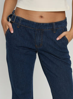 back view of model wearing Princess Polly Acapulco Low Rise Flare Jeans Dark Blue Wash Low Rise Jeans Jeans 