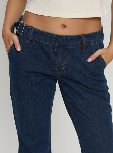 back view of model wearing Princess Polly Acapulco Low Rise Flare Jeans Dark Blue Wash Low Rise Jeans Jeans 