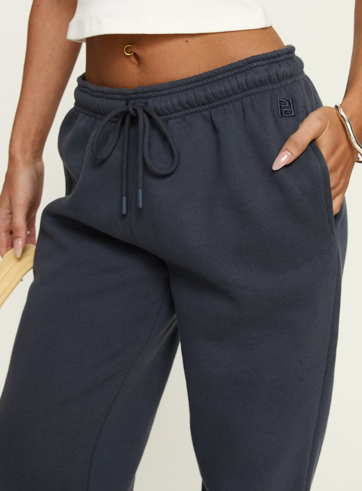 back view of model wearing Princess Polly Caspa Dream Fleece Oversized Ankle Cuff Jogger Navy High Rise Pants 