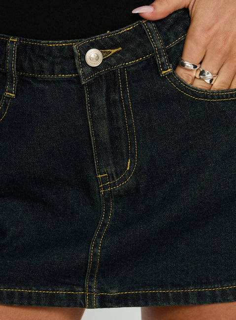   side view of model wearing Princess Polly Electric Star Patch Pocket Mini Skirt Dark Blue Wash Mini Skirts 