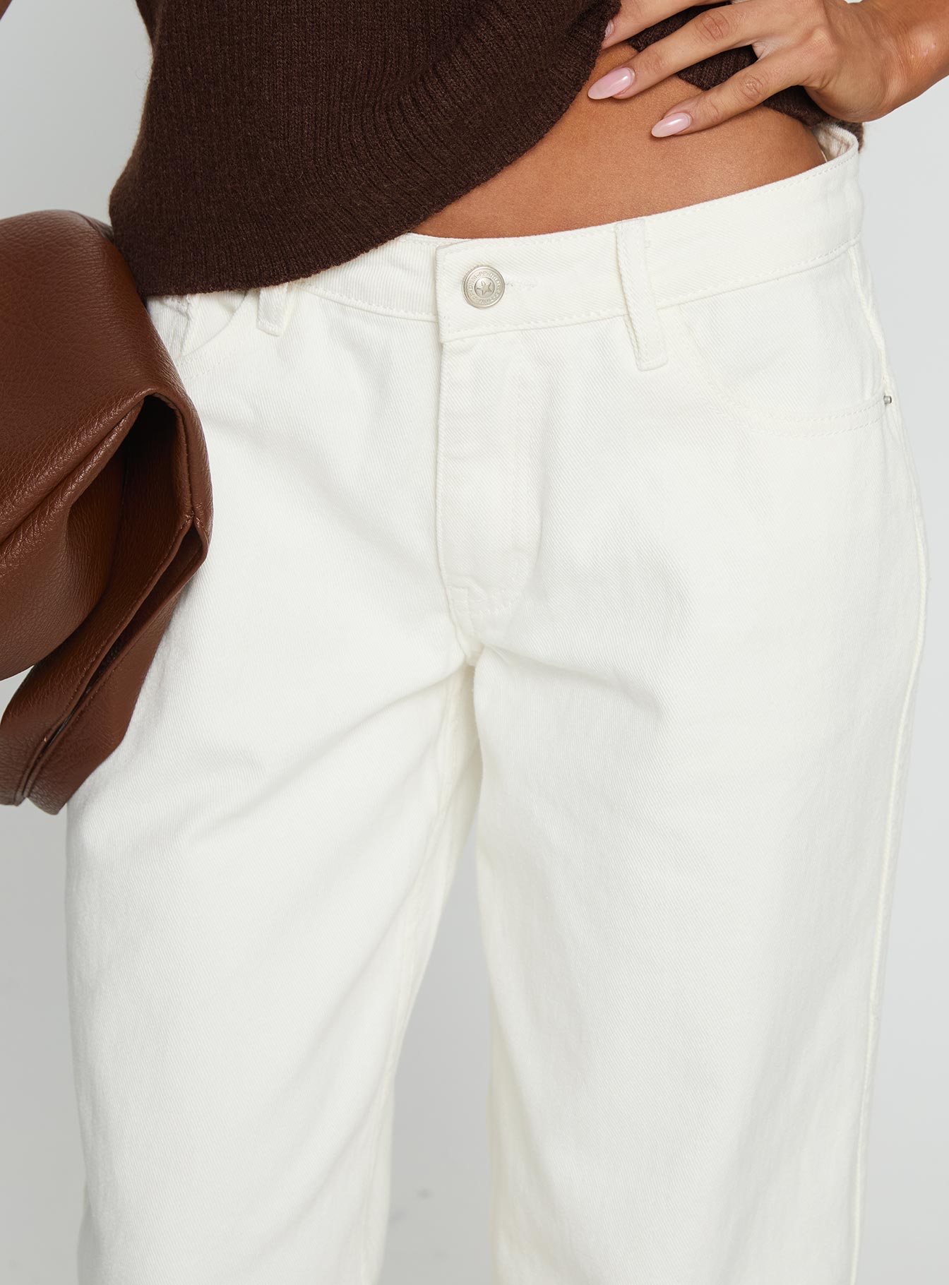 side view of model wearing Princess Polly Ramos Low Rise Wide Leg Jeans White Low Rise Jeans 