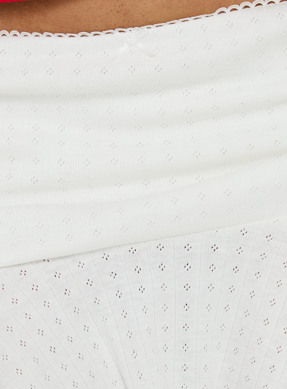 Highlighting the Elidia Pointelle Ruffle Mini Skirt in white womens-skirts with mini length product