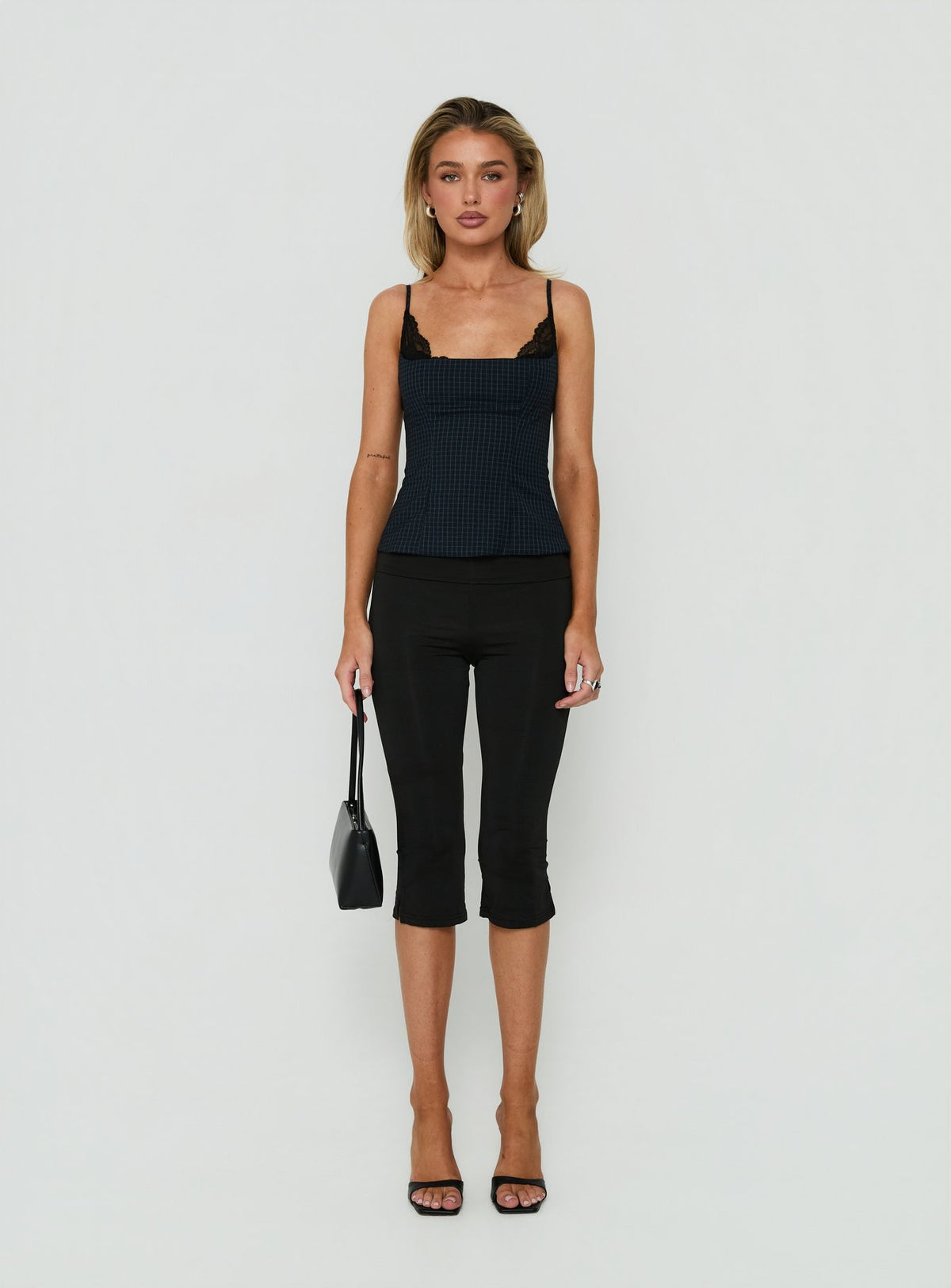 Presenting Avedon Foldover Waist Capri Pants in Black womens regular pants with high-rise on-body view of model wearing Princess Polly