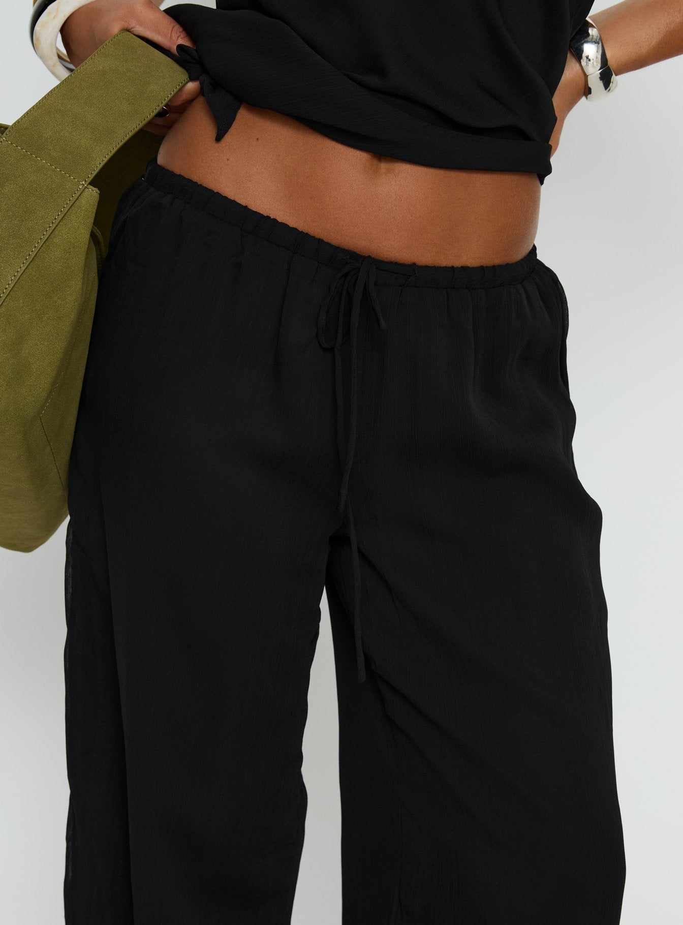 back view of model wearing Princess Polly Emorisa Mid Rise Chiffon Pant Black Mid Rise Pants 