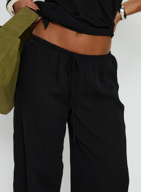 back view of model wearing Princess Polly Emorisa Mid Rise Chiffon Pant Black Mid Rise Pants 