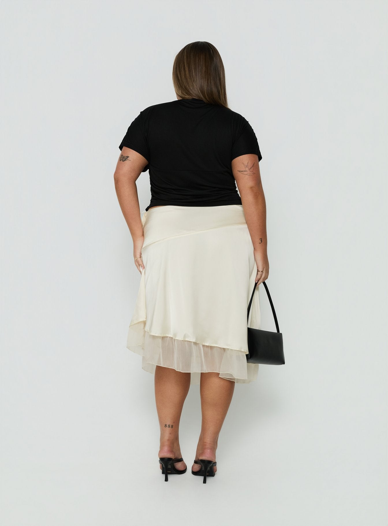 Explore the Rosemead Satin Midi Skirt Cream Curve in womens-skirts with midi length back view of model wearing