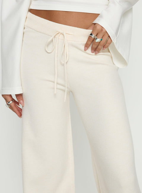 back view of model wearing Princess Polly Felisha Low Waist Knit Pants White Mid Rise Pants 