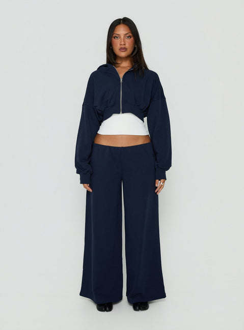 Showcasing the Kaeya Fleece Wide Leg Low Rise Pants Navy in womens regular pants with low-rise front view of model wearing Princess Polly