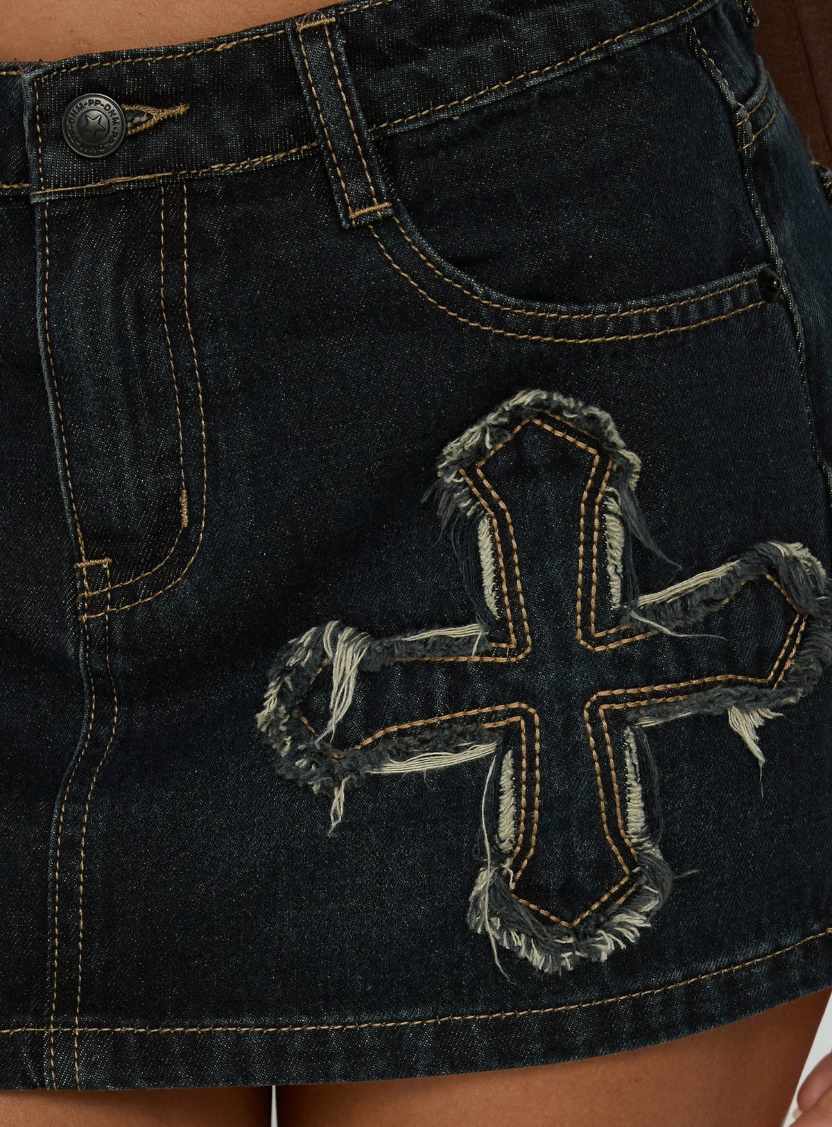 Highlighting the frayed cross applique on Barracuda Denim Mini Skirt Grunge Wash womens-skirts Princess Polly
