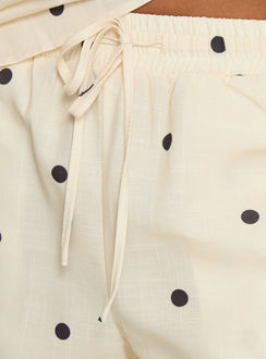 Crafted from cornsilk fabric, Bellara Tie Waist Pants Yellow Polka womens regular pants feature mid-rise and belt detail view of model wearing Princess Polly