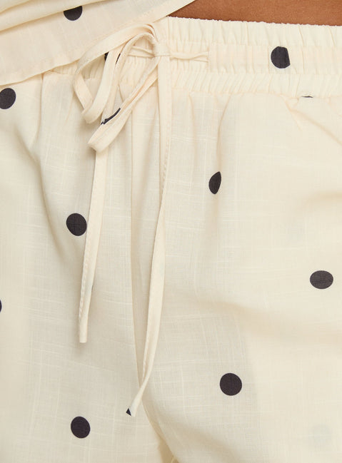 Crafted from cornsilk fabric, Bellara Tie Waist Pants Yellow Polka womens regular pants feature mid-rise and belt detail view of model wearing Princess Polly