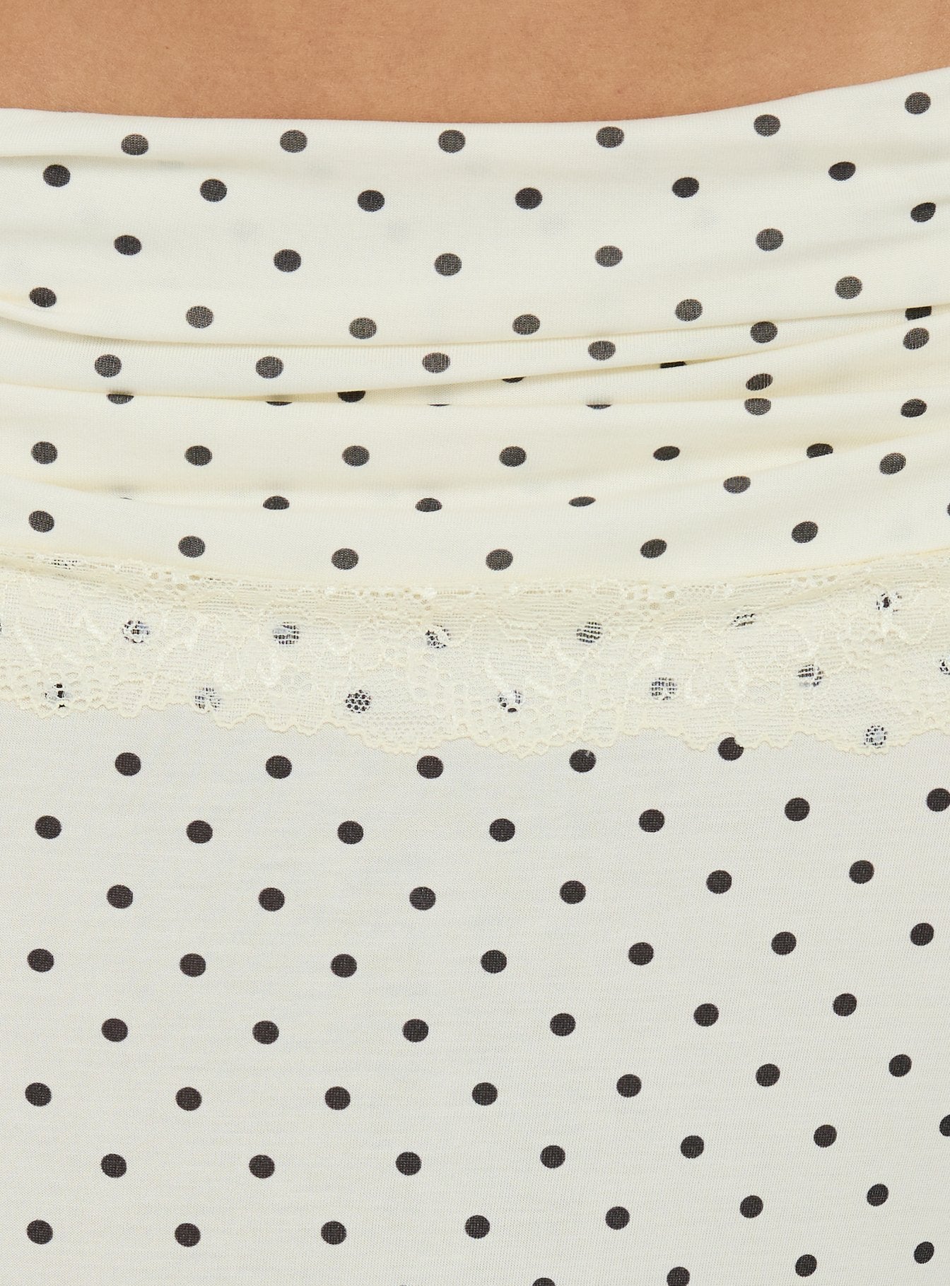 Highlighting the lace hem detail of Zespri Jersey Maxi Skirt Cream Polka Dot womens-skirts in ivory and black Princess Polly