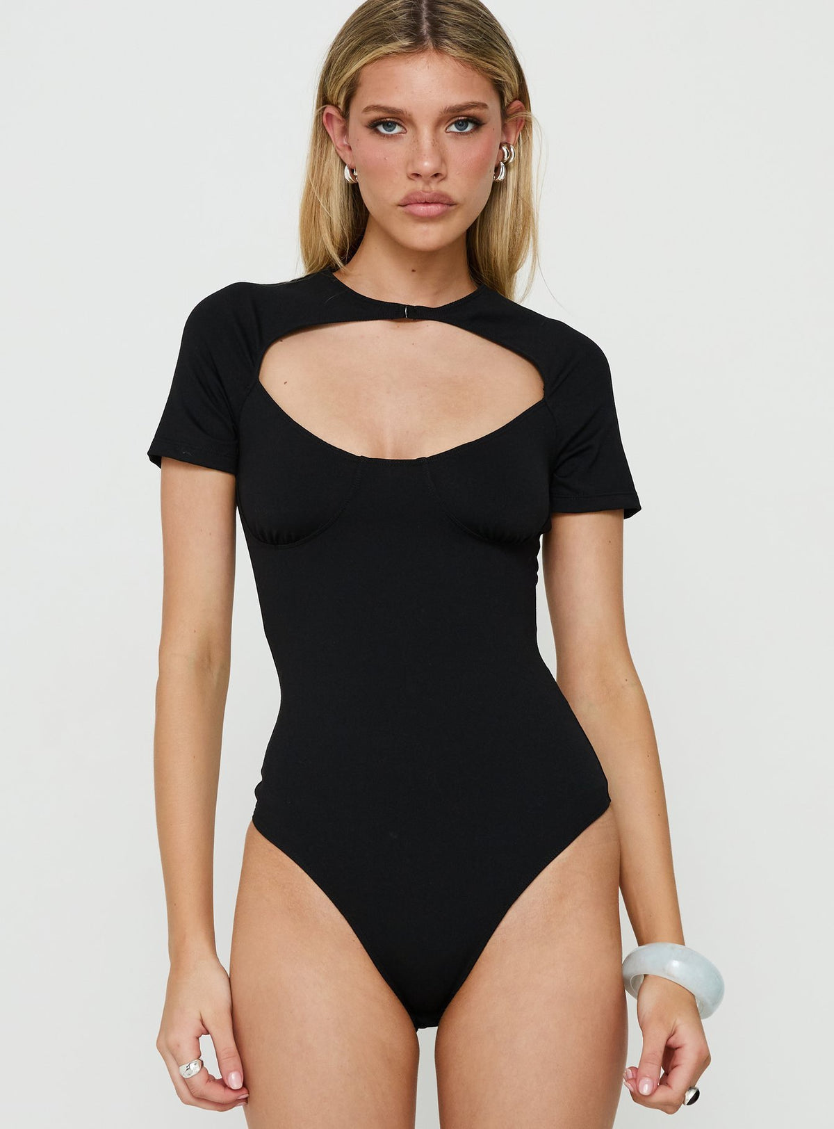 Explore Giallo Solid Bodysuit Black in womens bodysuit with short sleeves front view of model wearing Princess Polly