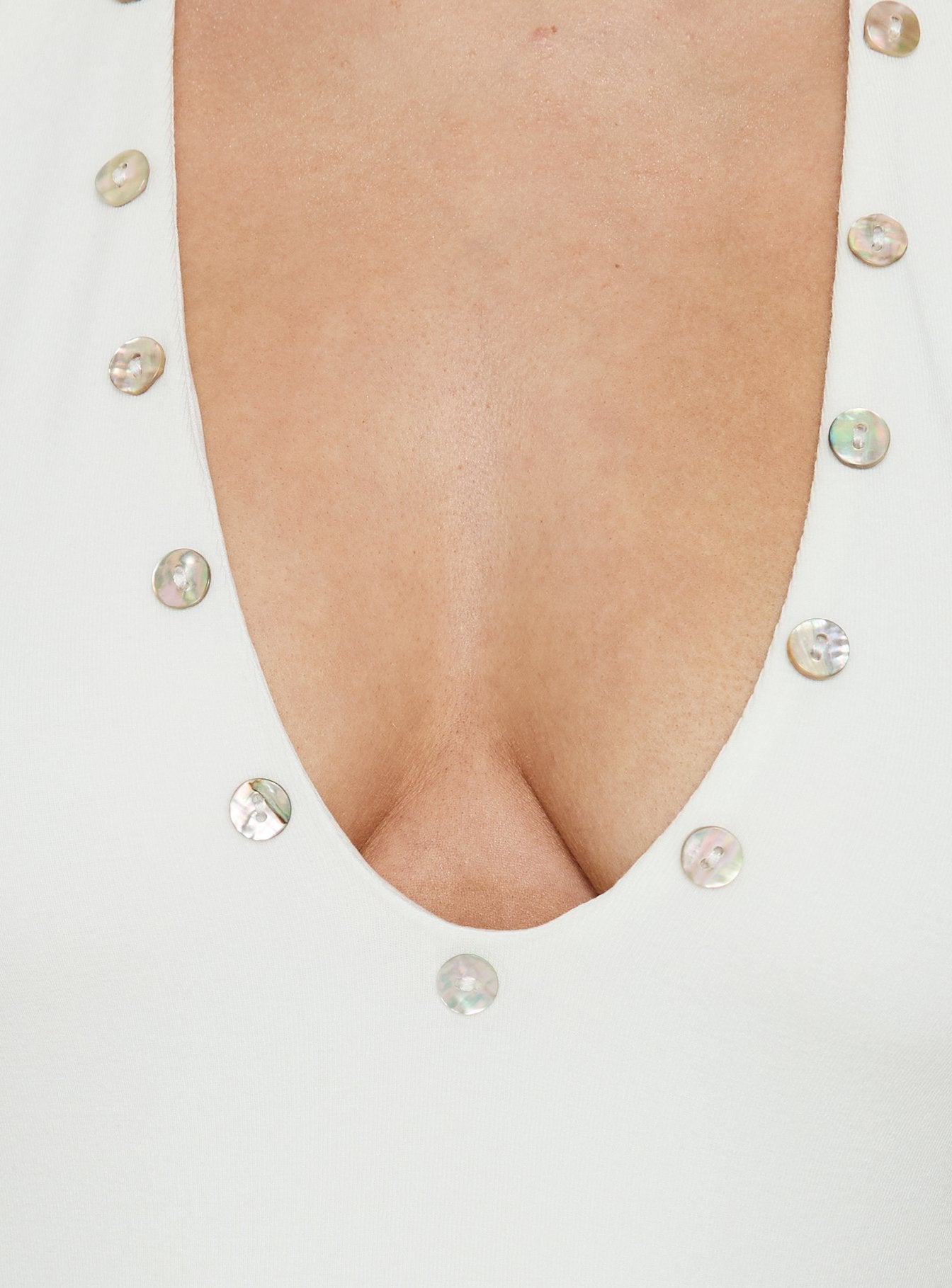 Highlighting the Cacilie Plunge Shell Bodysuit White with sleeveless halter neckline detail Princess Polly