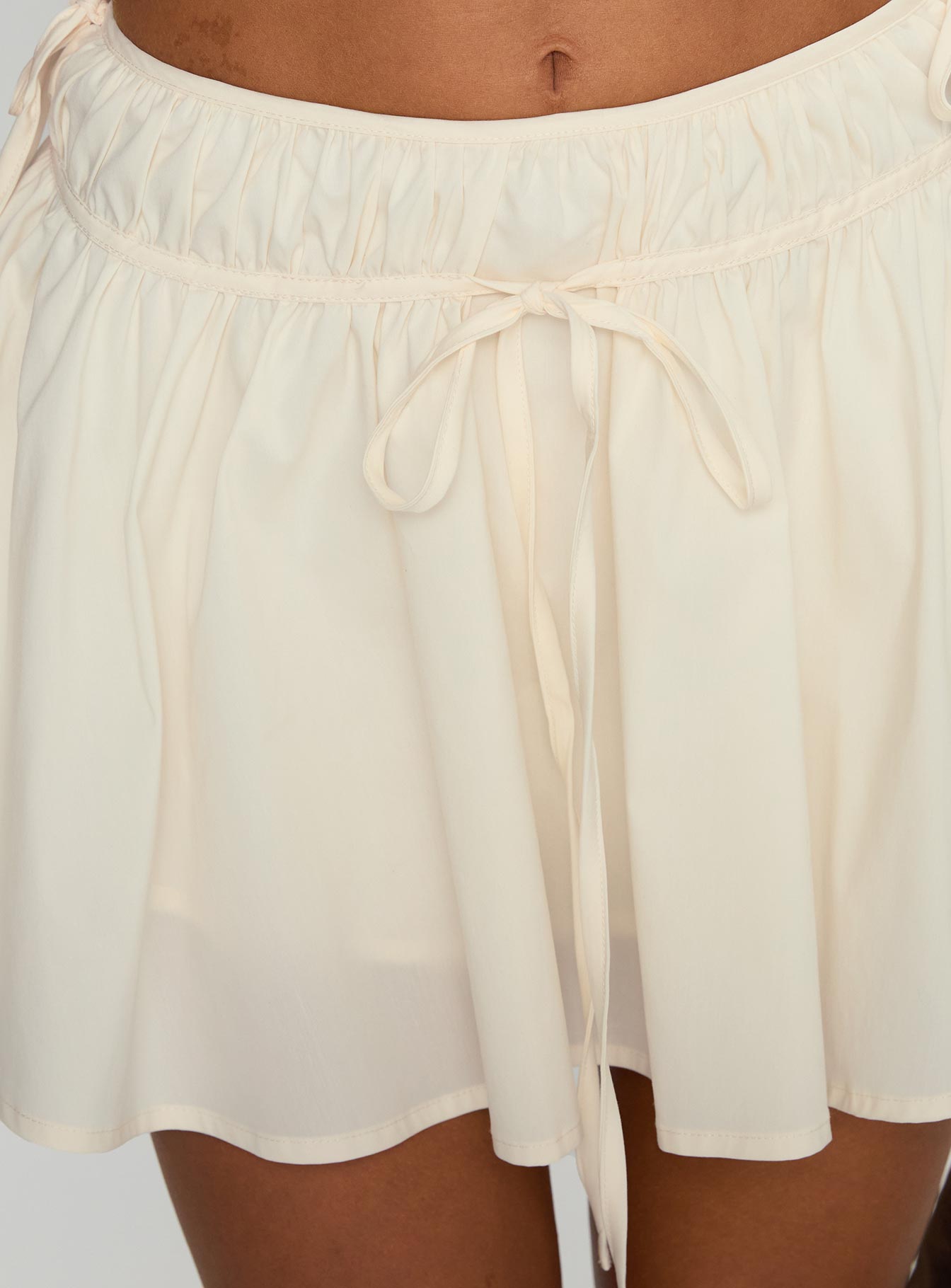 back view of model wearing Princess Polly Astelle Tie Up Mini Skirt Cream Mini Skirts 