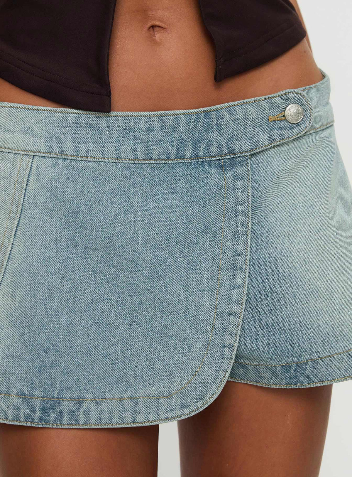 back view of model wearing Princess Polly Down For The Ride Denim Skort Light Wash Low Rise Shorts 