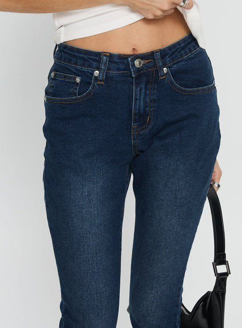back view of model wearing Princess Polly Illyssa Mid Rise Skinny Jeans Mid Blue Wash Mid Rise Jeans 