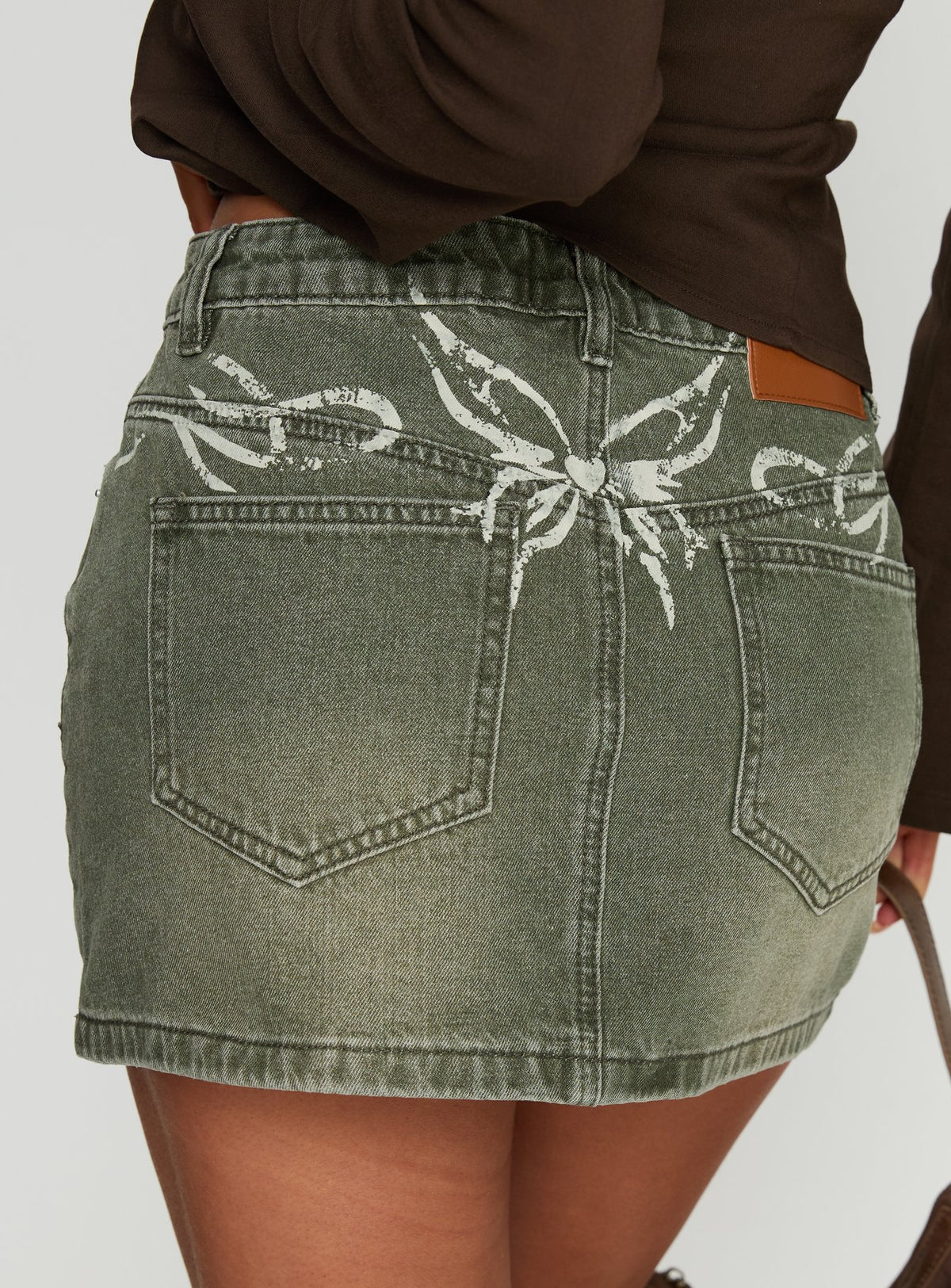   side view of model wearing Princess Polly Laynee Butterfly Mini Skirt Washed Green Mini Skirts 