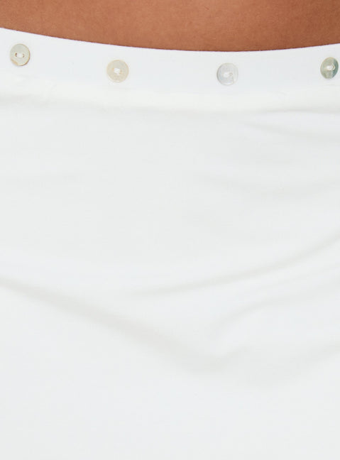 Highlighting the Esperia Button Layered Mini Skirt White in womens-skirts with mini length detail Princess Polly