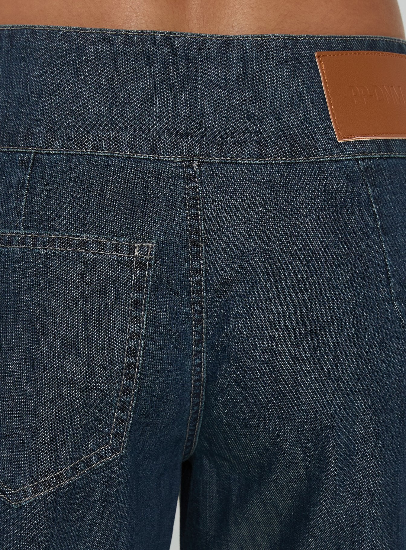 Highlighting the Nikoletta Mid Rise Wide Leg Cargo Jeans Dark Blue Wash in womens-jeans with mid-rise waistband detail
