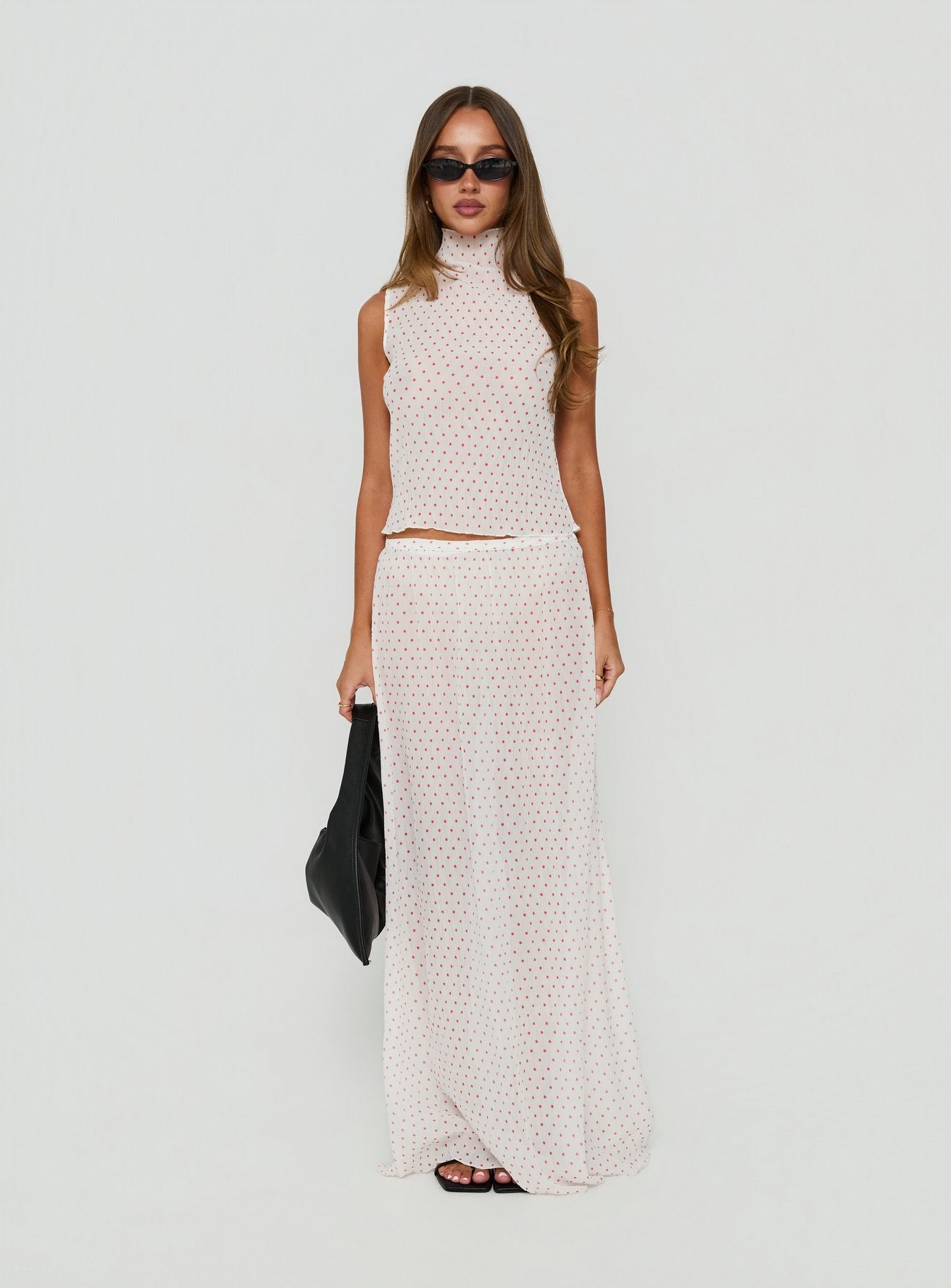 Showcasing the Ford Maxi Skirt White Red Polka Dot in womens-skirts with maxi length front view of model wearing Princess Polly