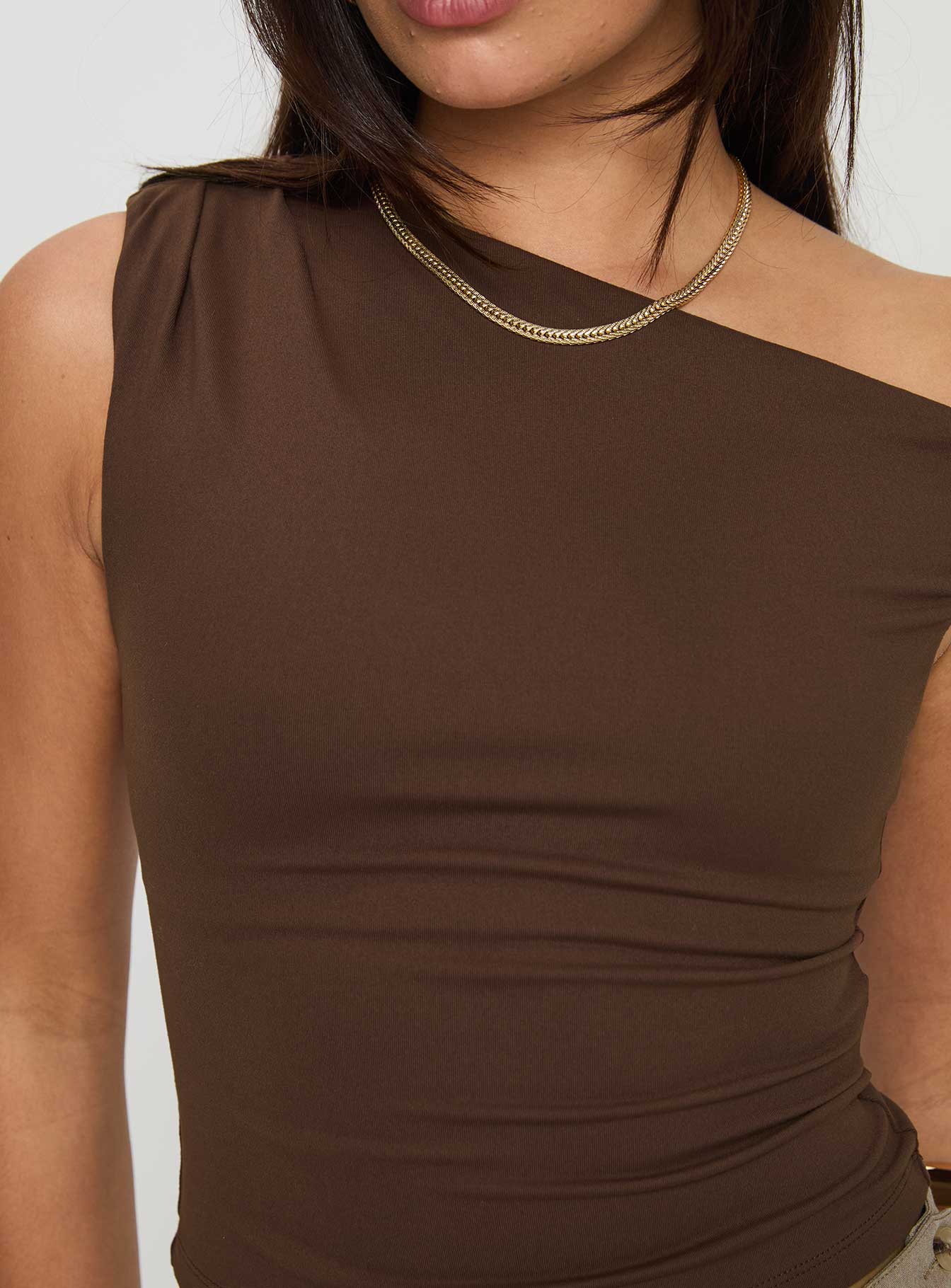back view of model wearing Princess Polly Danza Top Brown Sleeveless Asymmetric Neckline 