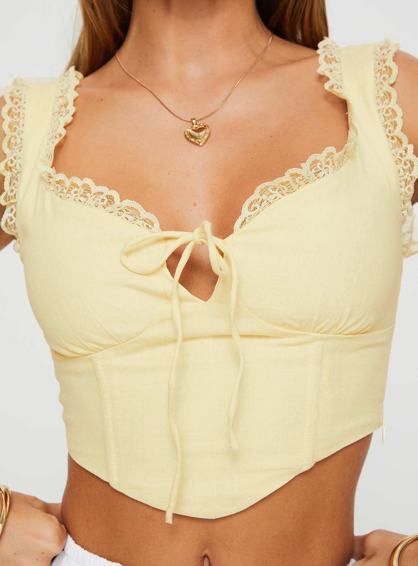 back view of model wearing Princess Polly Scarlett Top Yellow Sleeveless Sweetheart 