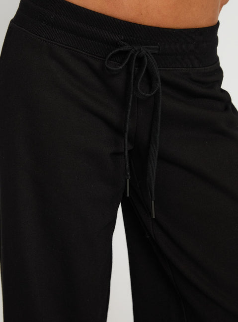 back view of model wearing Princess Polly Mindful Low Rise Pant Black Low Rise Pants 