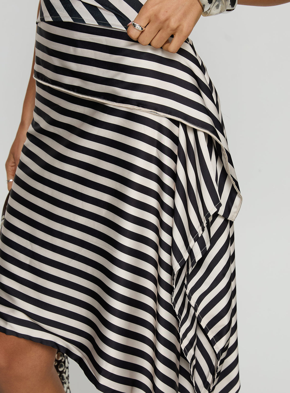   side view of model wearing Princess Polly Allure Midi Skirt Noir Stripe Midi Skirts 