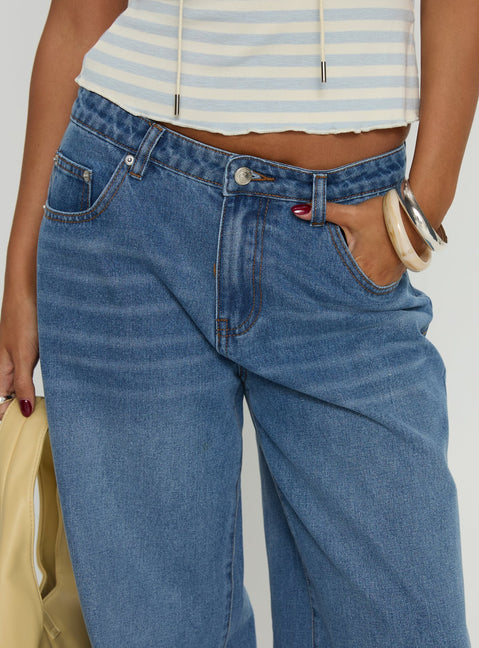 back view of model wearing Princess Polly Jacobie Mid Rise Wide Leg Jeans Mid Blue Wash Mid Rise Jeans 