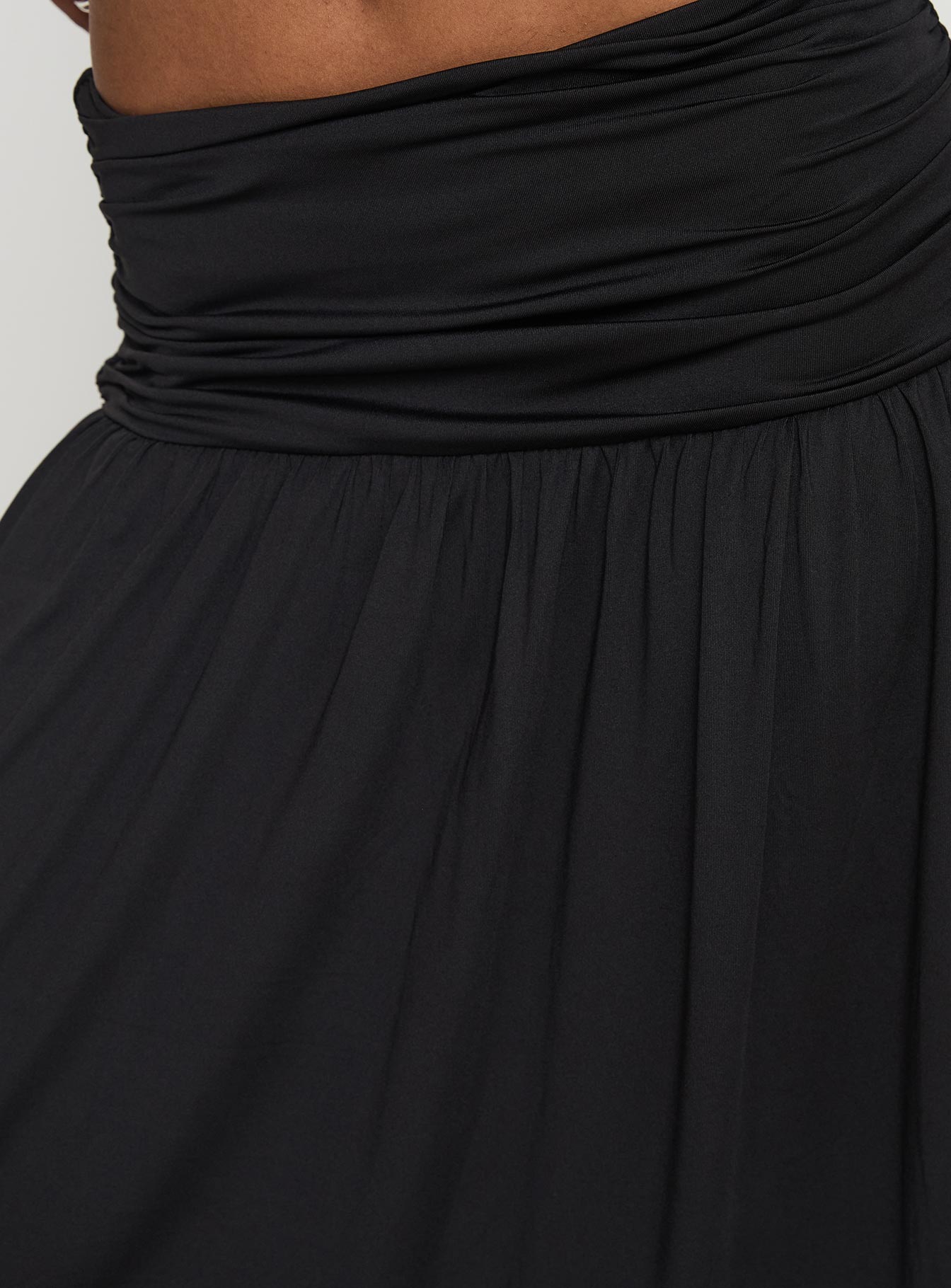 back view of model wearing Princess Polly Gezabele Asymmetrical Maxi Skirt Black Maxi 