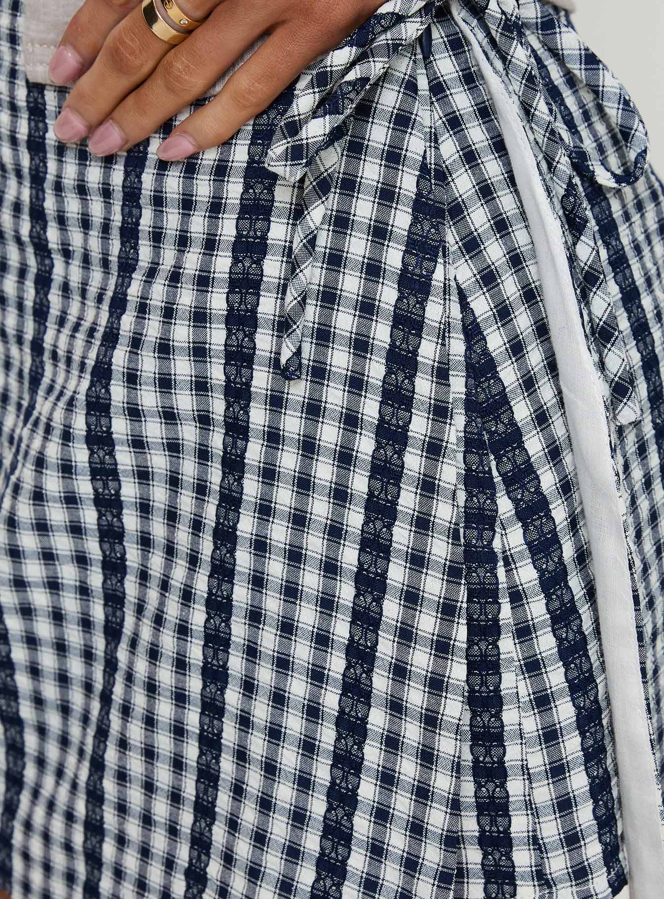 back view of model wearing Princess Polly Gulliver Tie Side Mini Skort Navy Gingham 