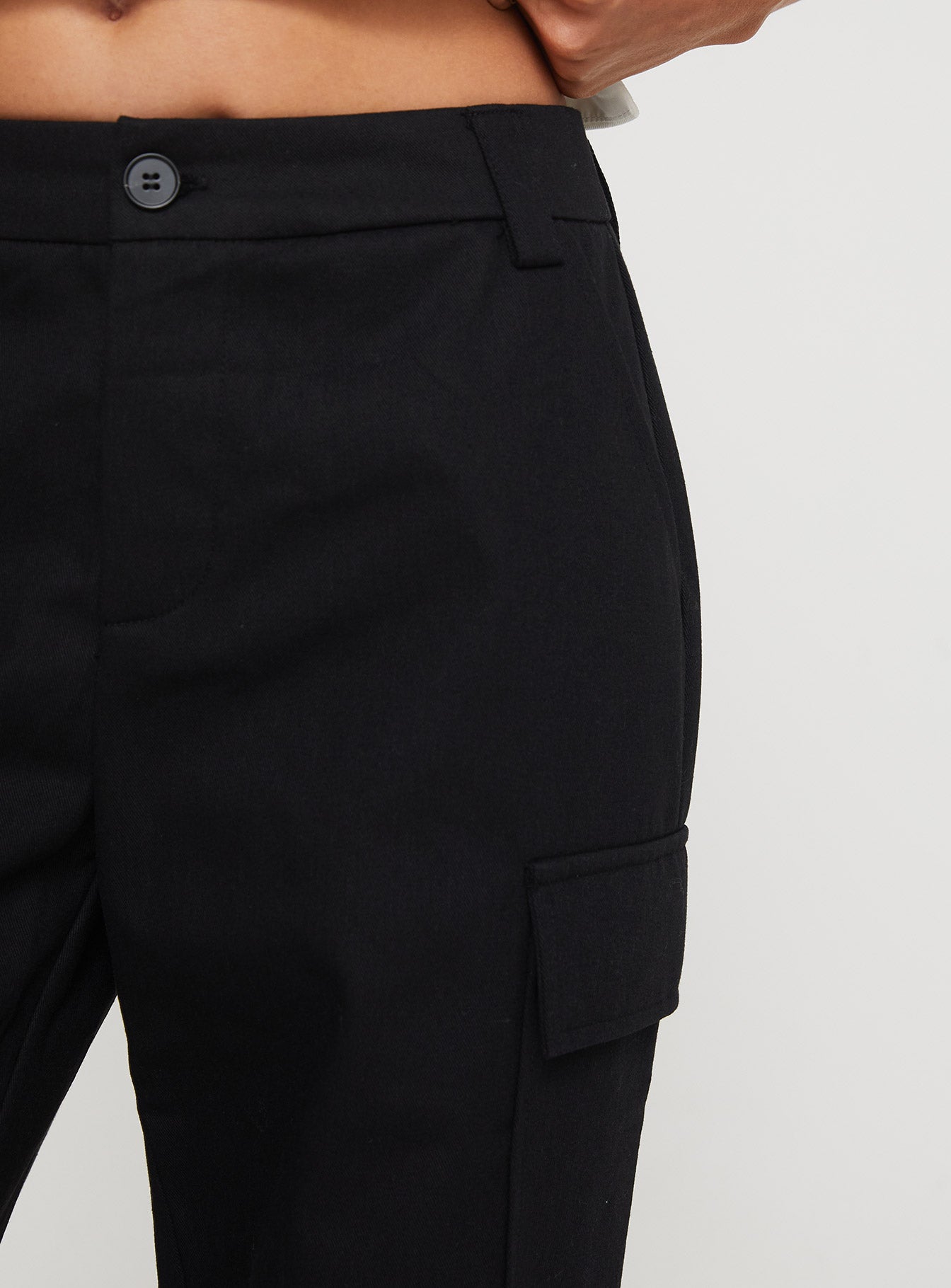 back view of model wearing Princess Polly Raider Low Waist Cargo Pant Black High Waisted Pants 