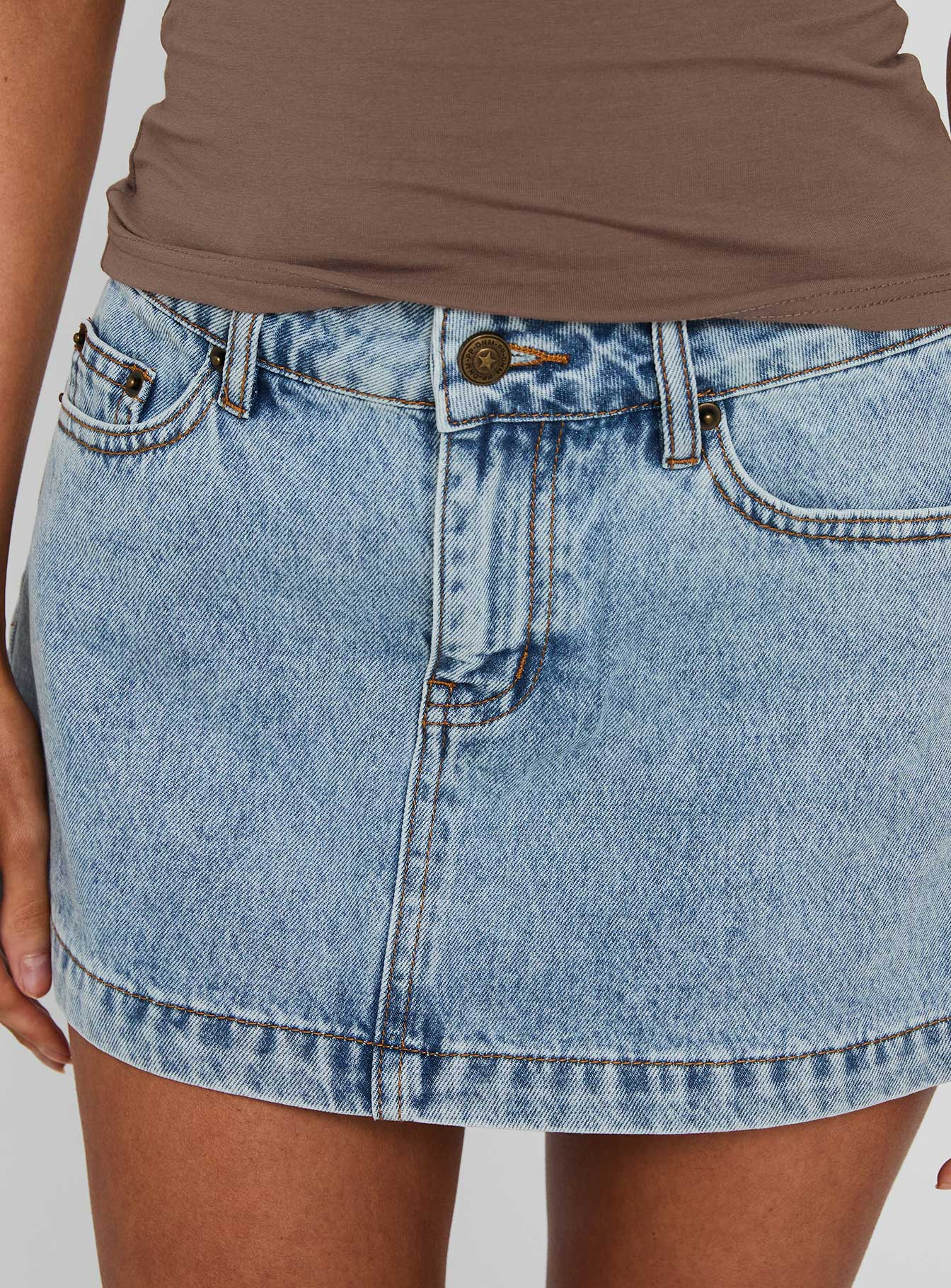 back view of model wearing Princess Polly Nicolina Low Rise Denim Mini Skirt Ice Blue Wash Tall Mini Skirts Skirts 