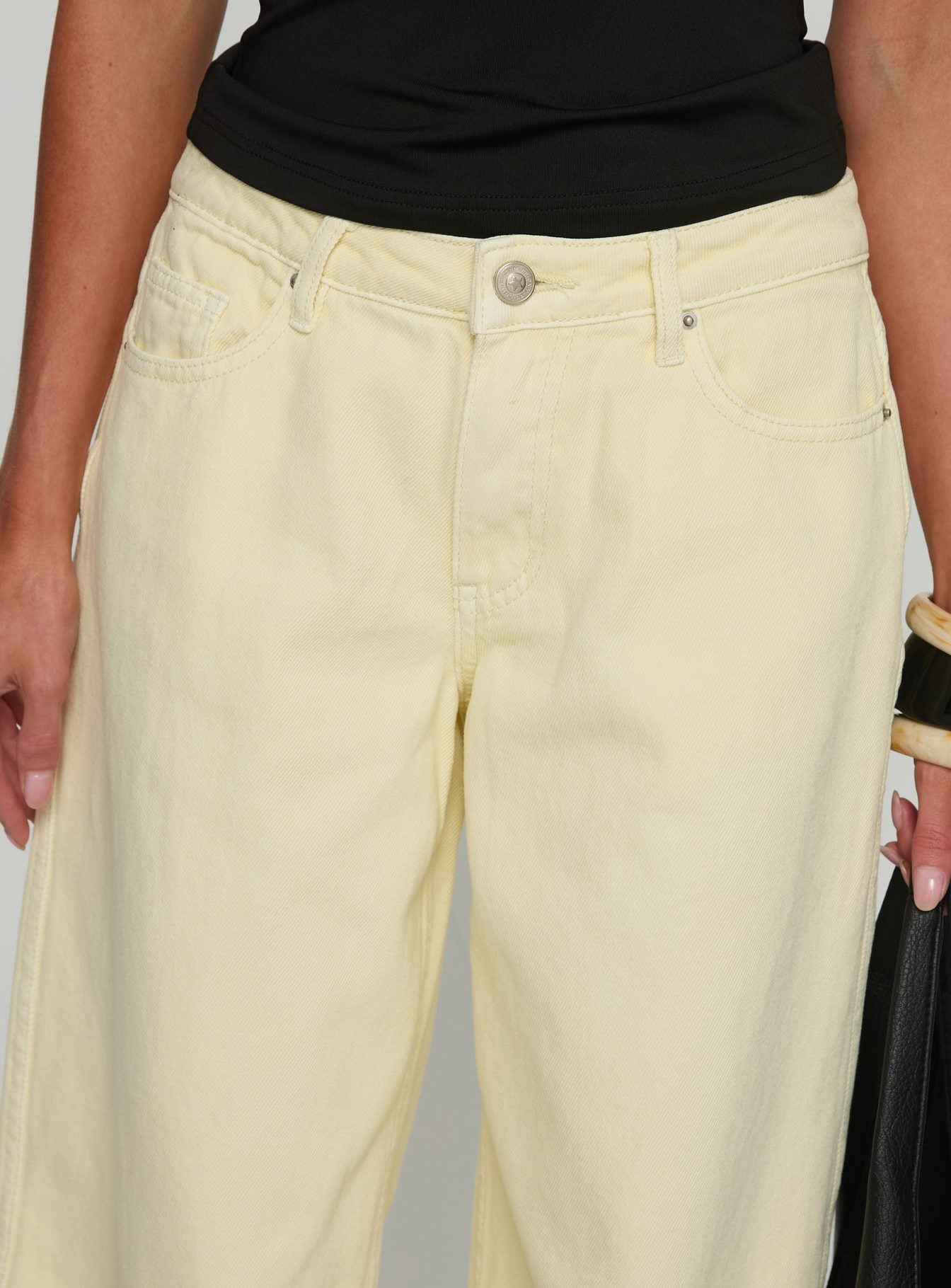 back view of model wearing Princess Polly Ramos Low Rise Wide Leg Jeans Butter Lemon Low Rise Jeans 