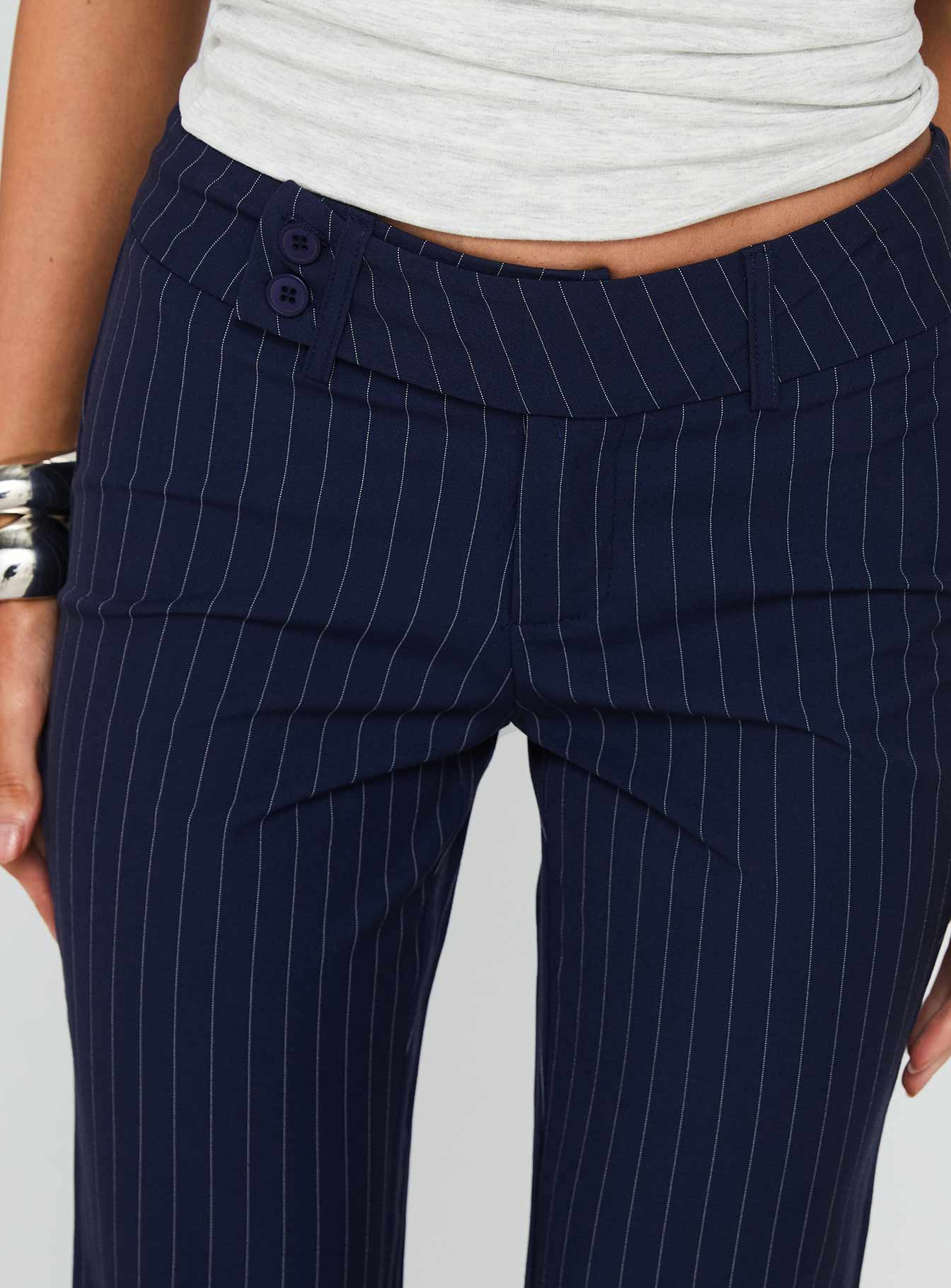 side view of model wearing Princess Polly Kinkirk Flared Pants Navy Pinstripe Low Rise Pants 