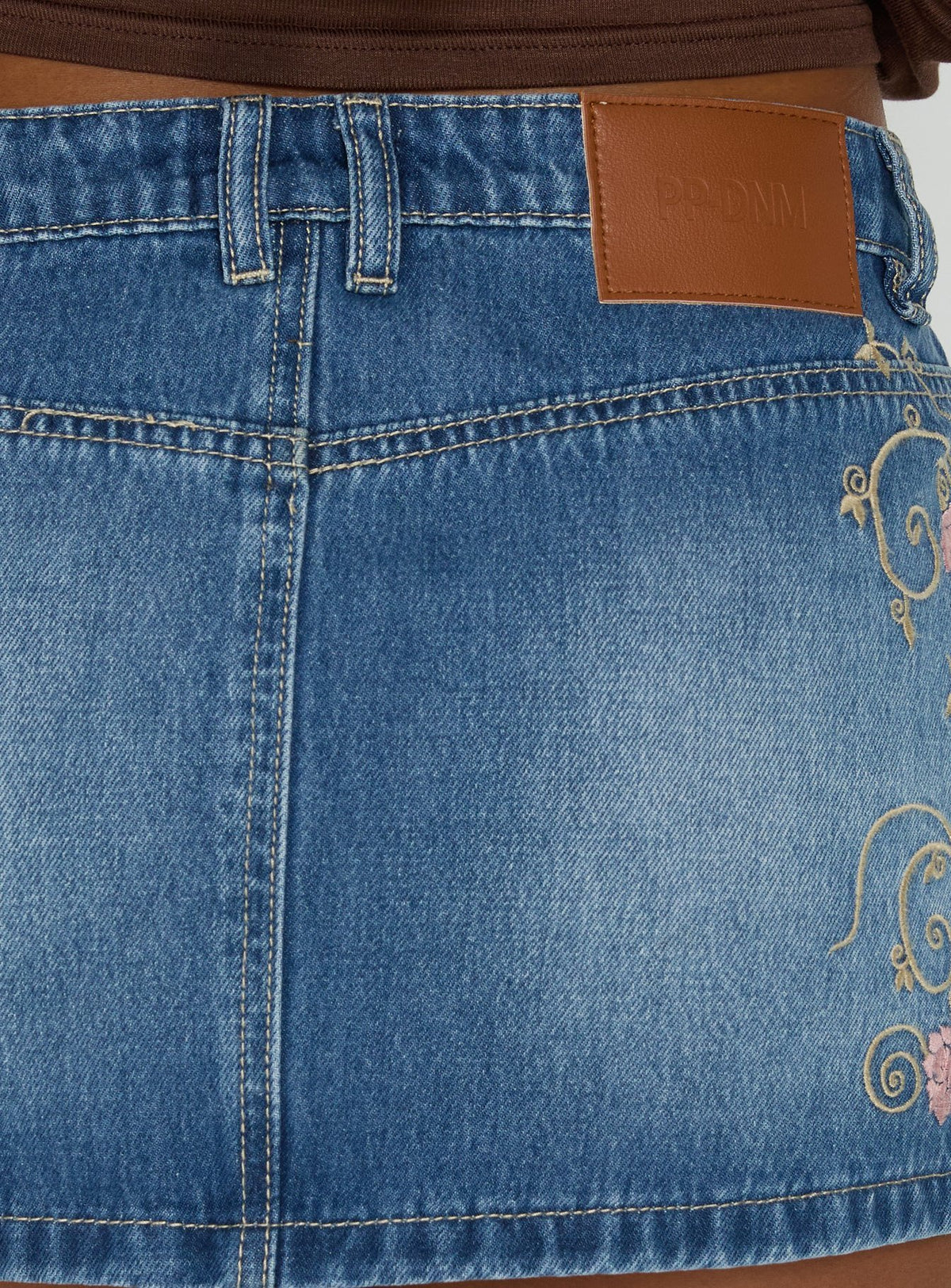Highlighting the Flatline Embroidered Denim Mini Skirt Mid Wash in womens-skirts with mini length product