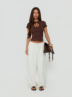 Showcasing the Peacemaker Tie Waist Relaxed Pants Off-White in womens regular pants featuring mid-rise styling front view of model wearing Princess Polly
