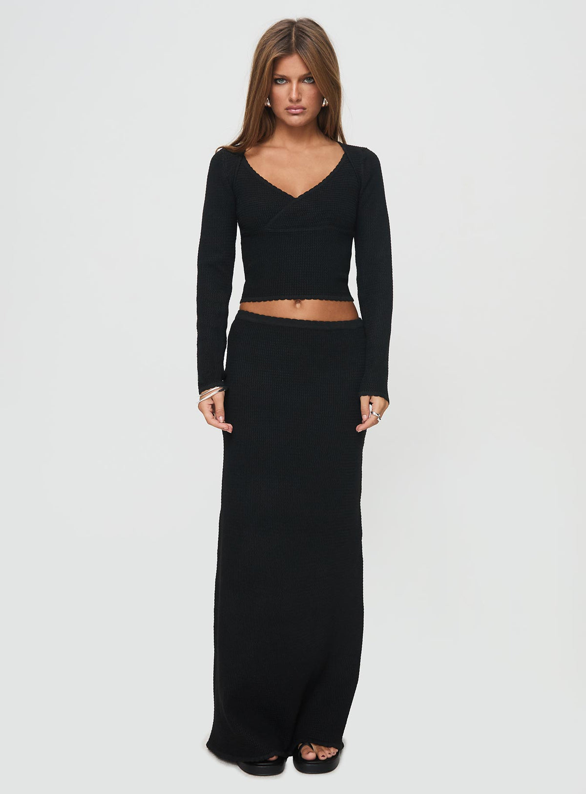 side view of model wearing Princess Polly Memi Long Sleeve Top Black Full Sleeves V-Neck 