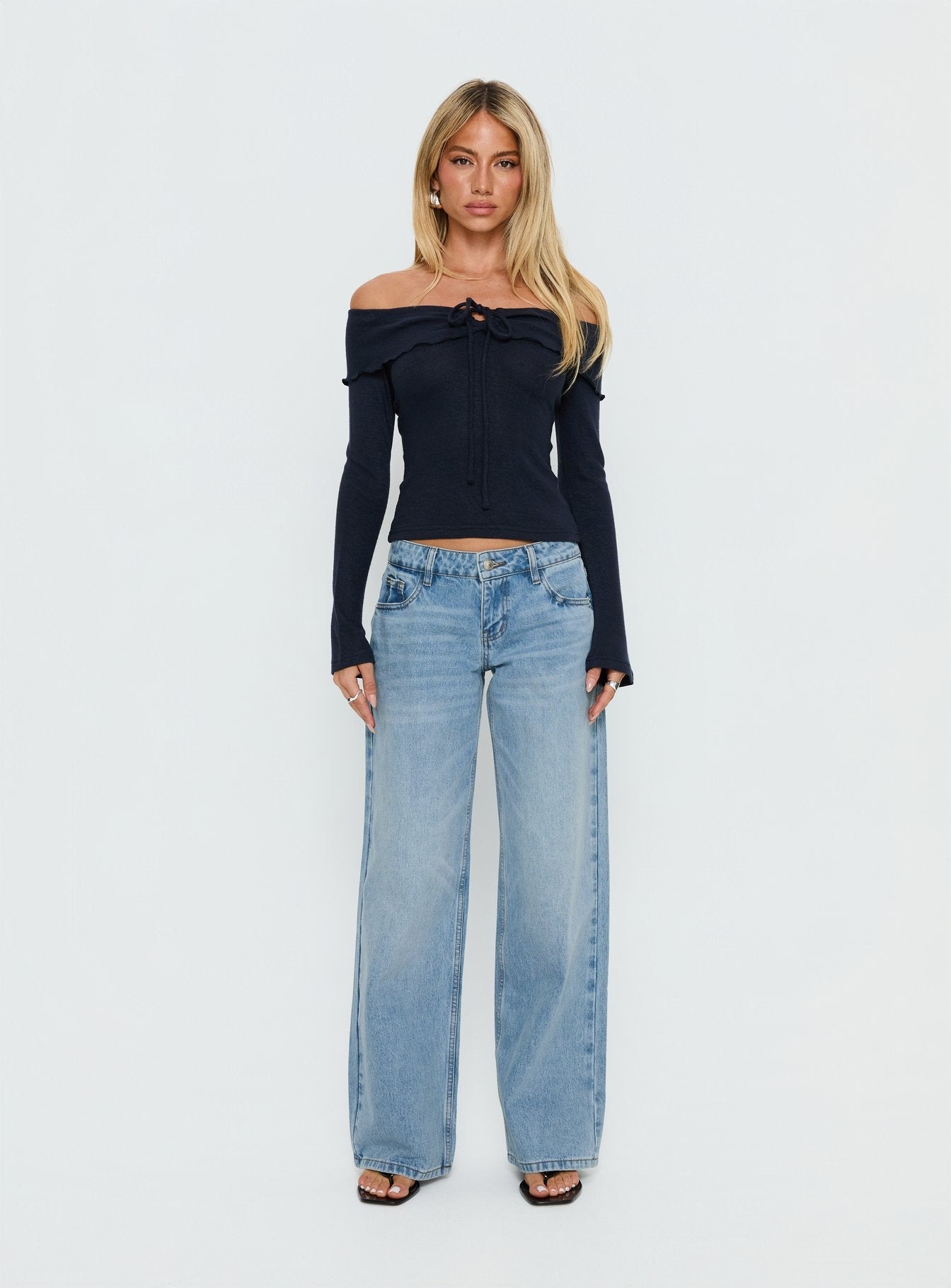 Showcasing Ellanor Low Rise Slouch Denim Jean Washed Mid Blue Wash Petite womens-jeans front view of model wearing Princess Polly