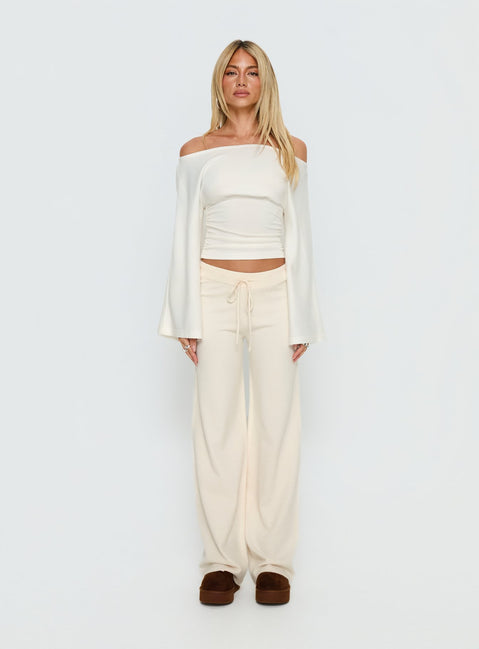 side view of model wearing Princess Polly Felisha Low Waist Knit Pants White Mid Rise Pants 