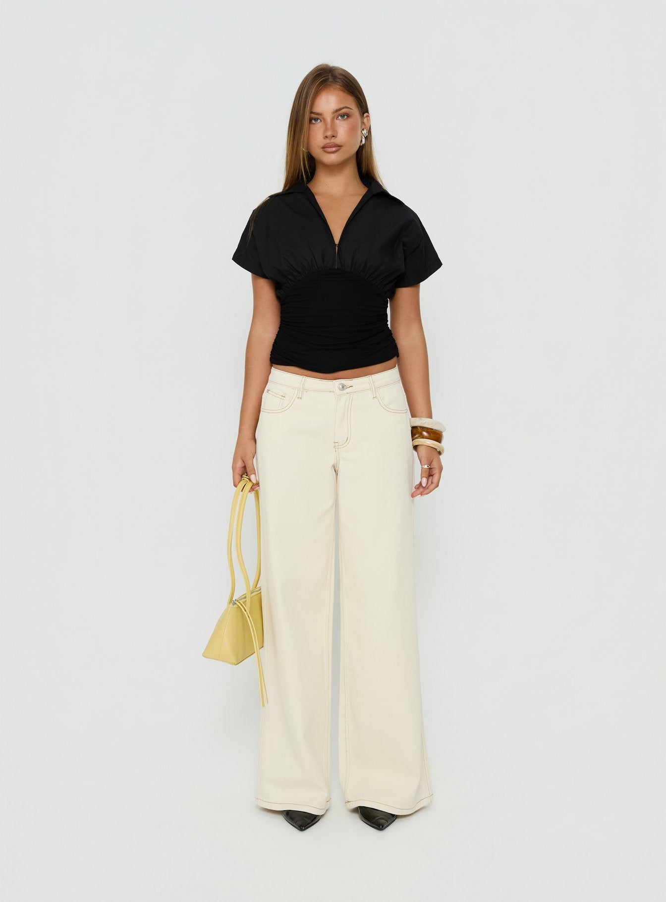 Showcasing the Ramos Low Rise Wide Leg Jeans Cream in womens jeans with low-rise waist front view of model wearing Princess Polly