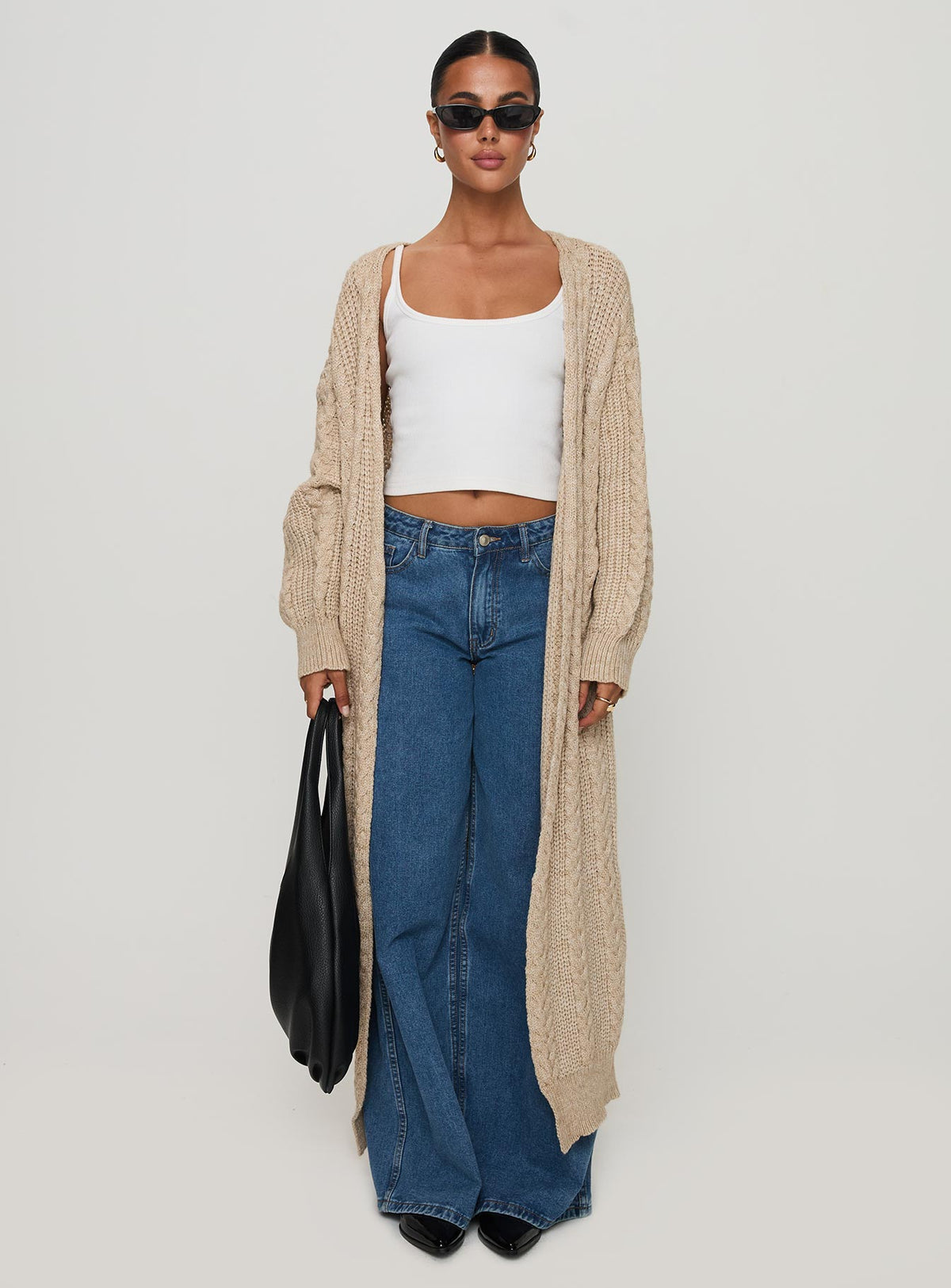 side view of model wearing Princess Polly Orkid Cable Knit Cardigan Beige Long 